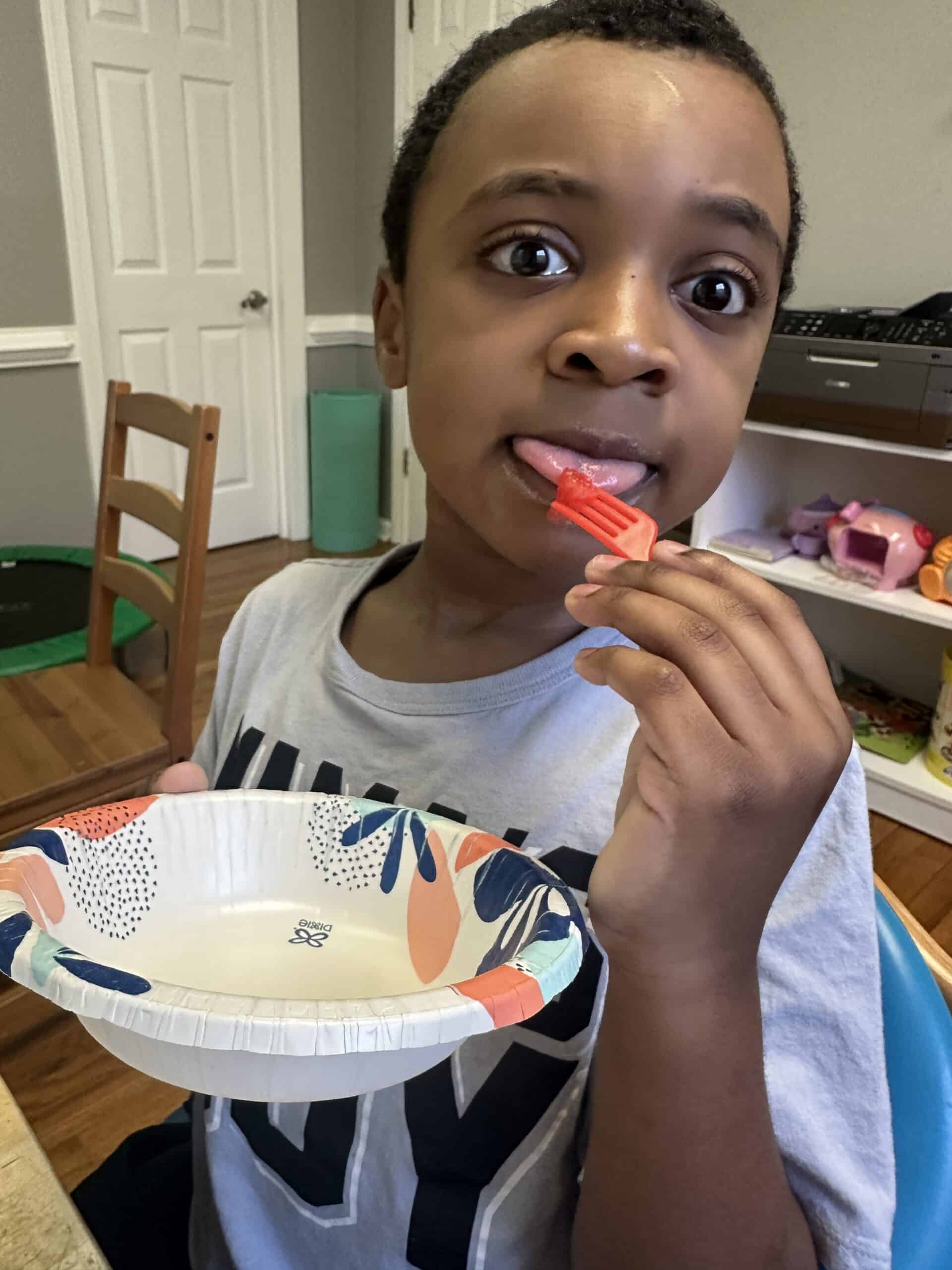 Child holding a paper plate.