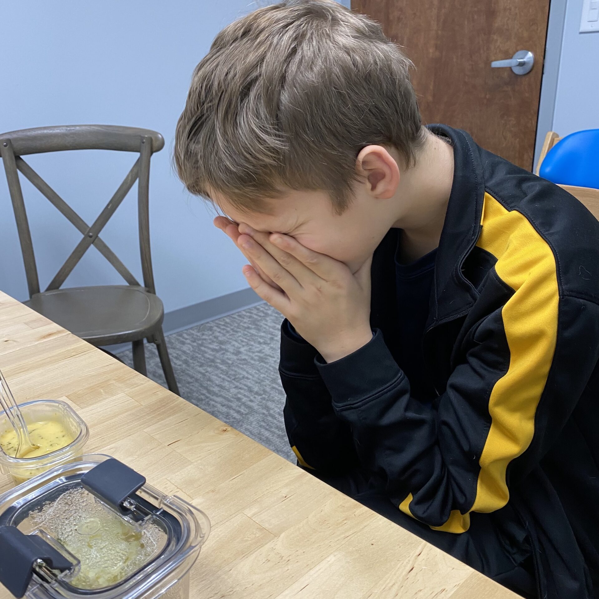 Child sitting quietly at table.